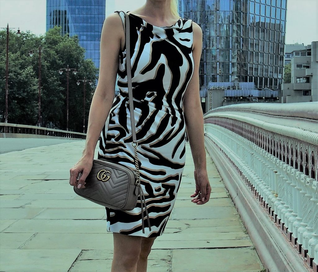 Zip top GG bag worn over the shoulder