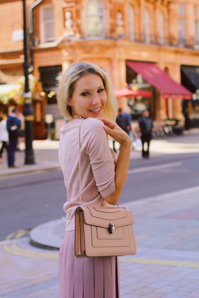 Serpenti Forever bag worn over the shoulder with a full length strap