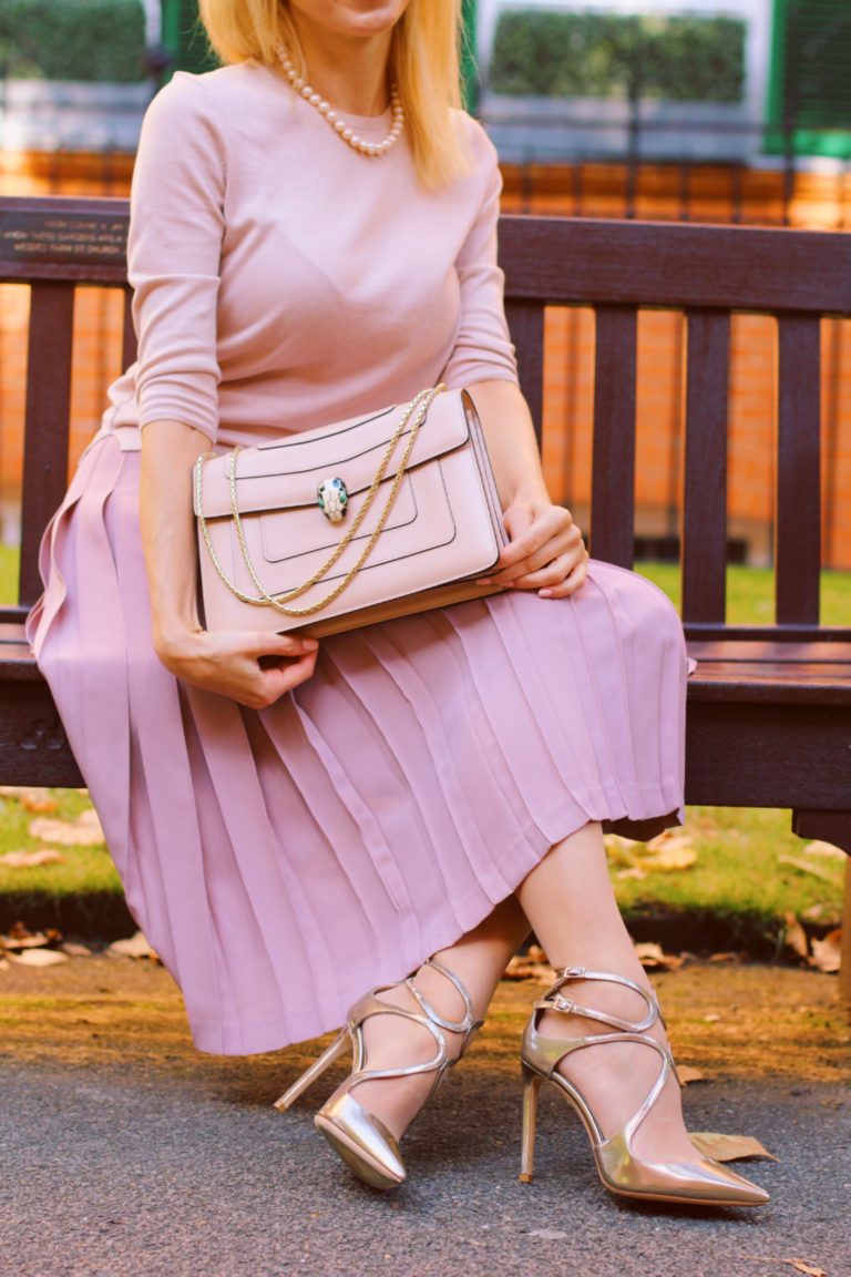 Image of Serpenti Forever bag held on the kneeheld