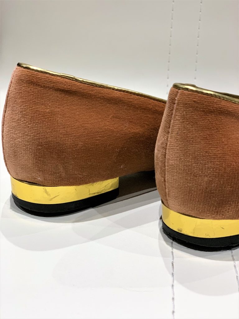 Heels of a well used pair of kitty flats