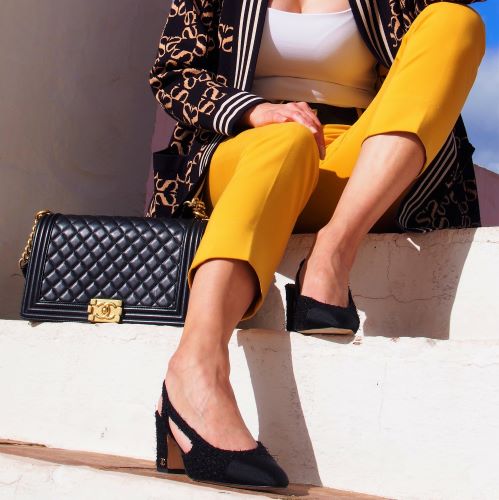 Chanel slingback heels next to Chanel Boy bag