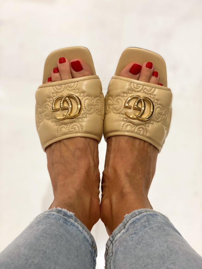 Image of beige slip-ons in embroidered leather.
