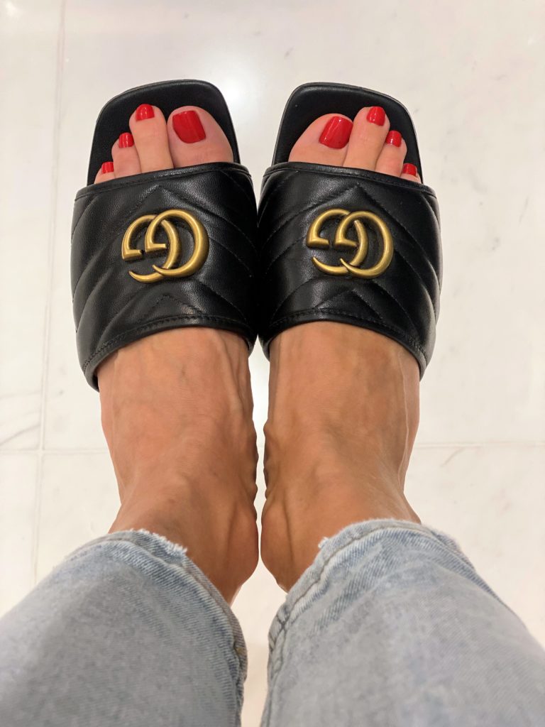 Image of black flat sandals in chevron leather finish.