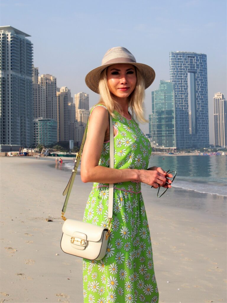 A white Gucci Horsebit 1955 bag hanging on the shoulder